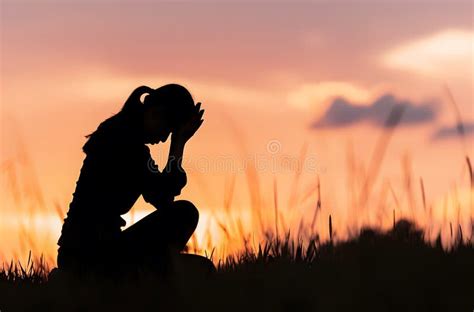 Silhouette Of Woman Kneeling In Prayer At Sunset Stock Illustration