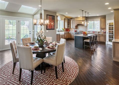 A Dining Room And Kitchen Area In A House With Hardwood Floors Large