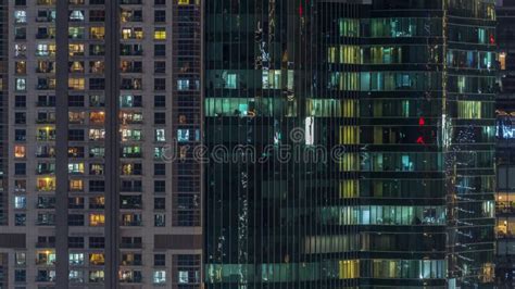 Office And Residential Buildings Windows Illuminated At Night Timelapse