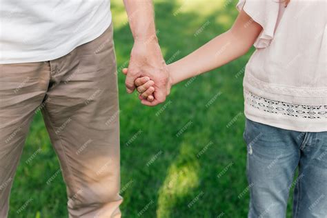 Premium Photo Partial View Of Grandfather And Granddaughter Holding