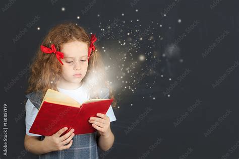 Little girl reading the book. Education concept. Stock Photo | Adobe Stock