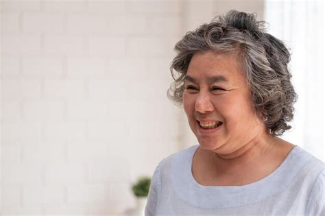 Premium Photo Close Up Of Smiling Mature Woman Looking Away