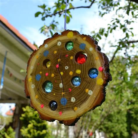 A Piece Of Wood With Different Colored Glass Beads Hanging From It S