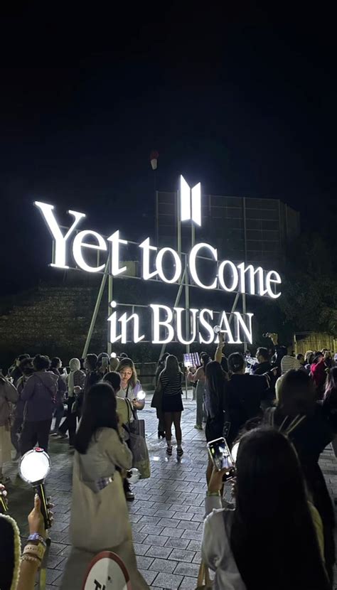 People Are Walking Around In Front Of The Entrance To Yet To Come In Busan