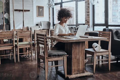 Working on new project. Beautiful young African woman in smart casual