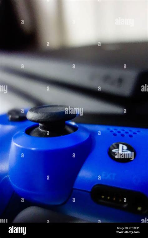 Sony black Playstation 4 Pro game console and blue wireless controller ...