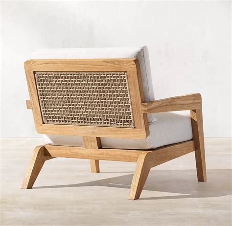 A Chair Made Out Of Wood And Wicker With A White Cushion On The Back