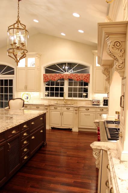 Luxurious Mediterranean Kitchen With A Custom Wood Hood And Cherry Wood