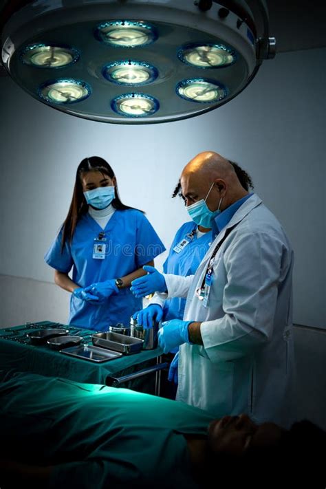 A Medical Professor Is Teaching Surgery To Medical Students Working