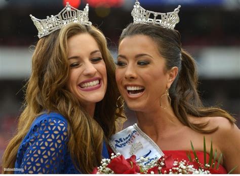 Two Beautiful Women Standing Next To Each Other With Crowns On Their