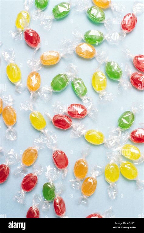 Scattered Many Colour Candy In Clear Plastic Wrapper On Blue Background