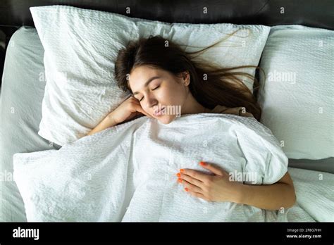 Young Woman Sleeping And Resting Alone In Her Bed Dreaming View From