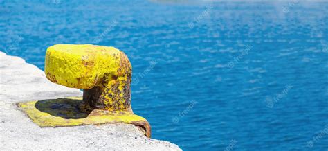 Premium Photo Yellow Rusty Port Bollard On Greek Island Harbor Pier