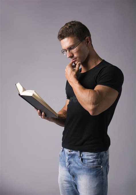 Handsome Muscular Man Reading Big Book On Grey Stock Image Image Of