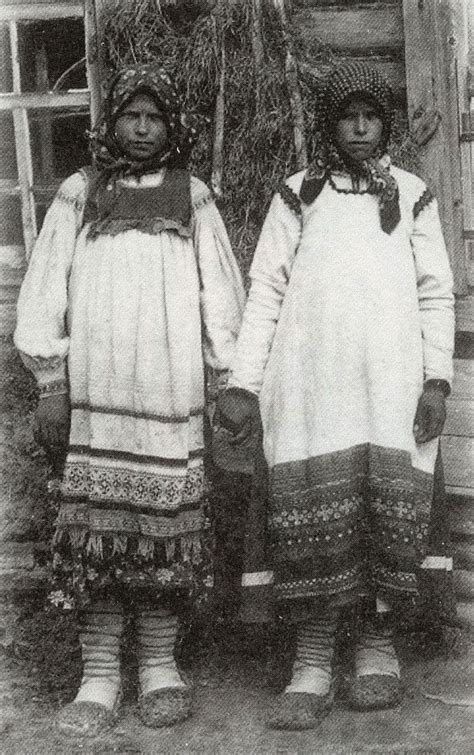 Two Women In Native Clothing Standing Next To Each Other