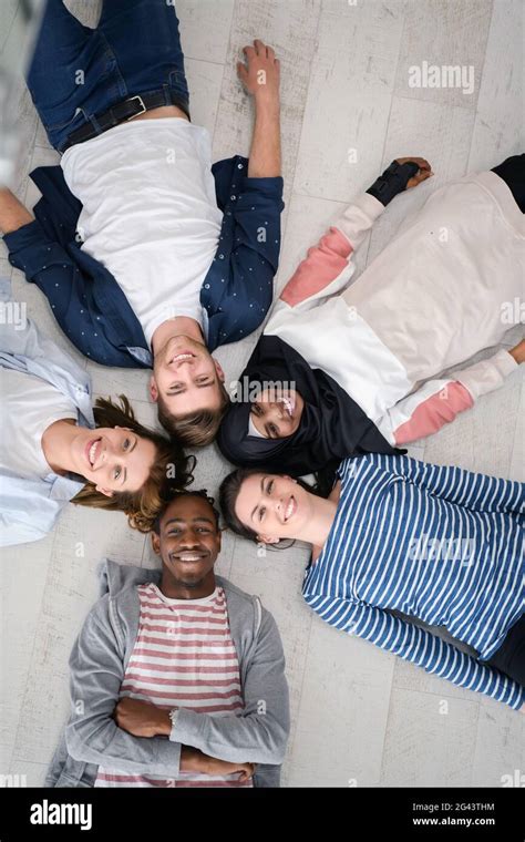 Top View Of A Diverse Group Of People Lying On The Floor And