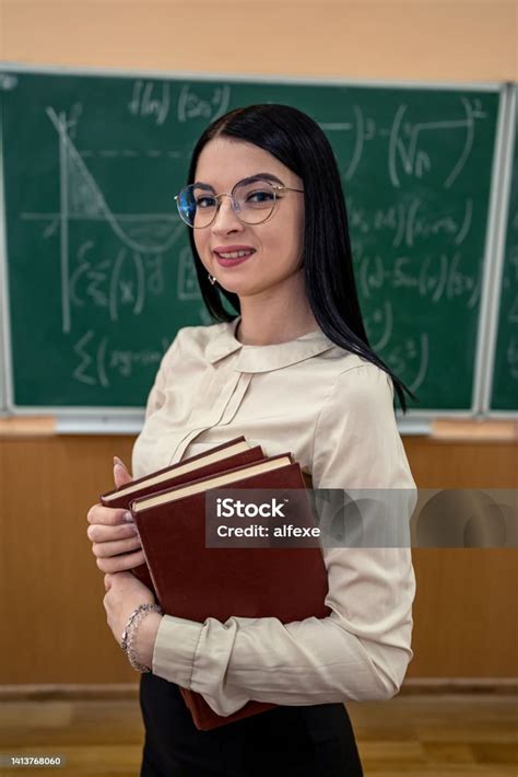 Portrait Female Teacher Or A Student Against Blackboard And Explain A