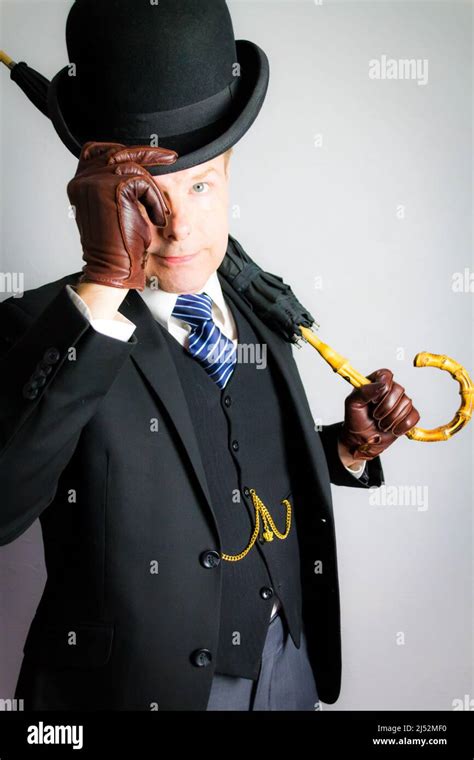 Portrait Of British Businessman In Dark Suit And Leather Gloves