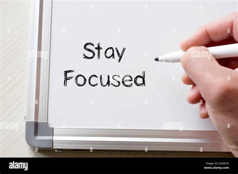 Human Hand Writing Stay Focused On Whiteboard Stock Photo Alamy