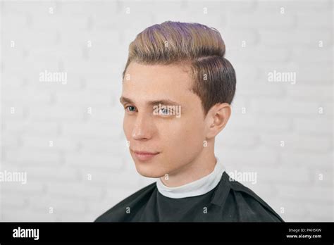 Young Boy Posing With Toned Lilac Hair On White Brick Background Male