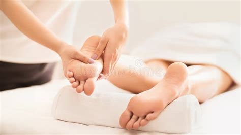 Acupressure And Reflexology Concept Masseur Doing Foot Massage Stock