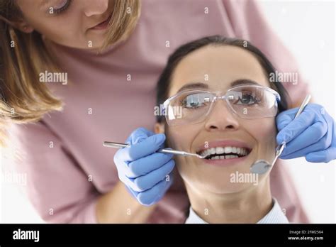 Dentist Doctor Examines Oral Cavity Of Woman In Office Stock Photo Alamy