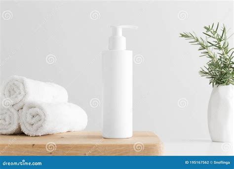 White Cosmetic Shampoo Dispenser Bottle Mockup with Towels and a ...