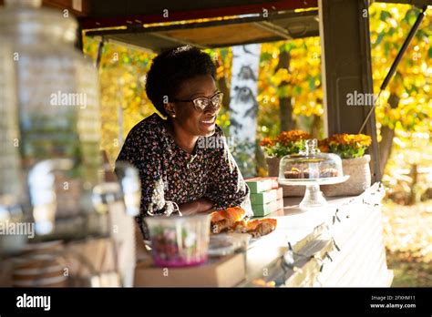 Happy Female Food Cart Owner In Sunny Park Stock Photo Alamy