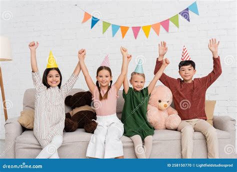 Excited Multiethnic Kids in Party Caps Stock Photo - Image of friends ...