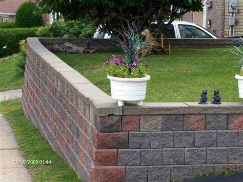 How To Build A Retaining Wall The Mortarless Way Building A Retaining Wall Small Yard