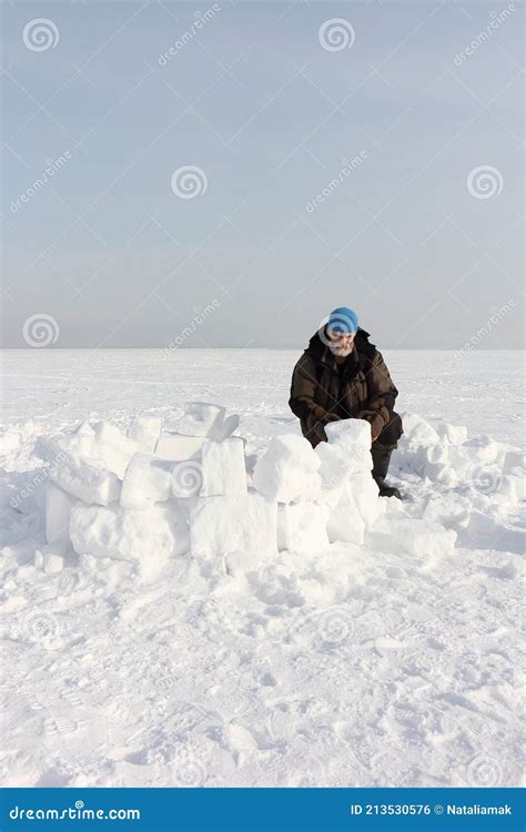 Man Building An Igloo From Snow Blocks Stock Photography ...