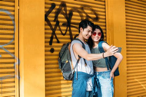 Young Asian Couple Taking A Selfie By Stocksy Contributor Lumina