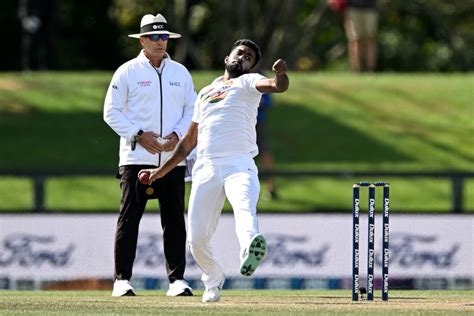 Asitha Fernando Bowls With Umpire Chris Gaffaney Standing Behind