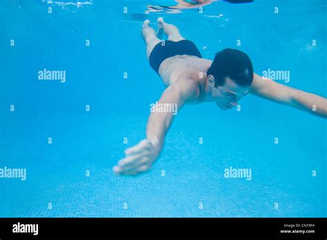 Man swimming underwater Stock Photo - Alamy