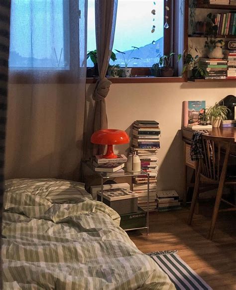 A Bedroom With A Bed Desk And Bookshelf In Front Of A Window