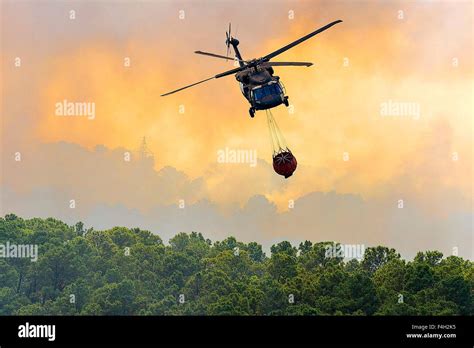 A Texas Army National Guard Uh 60 Black Hawk Helicopter Drops Water On