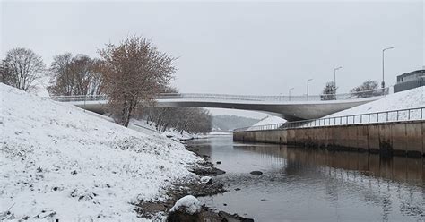 pedestrian 'bridge-plaza' converges historic lithuanian city with park