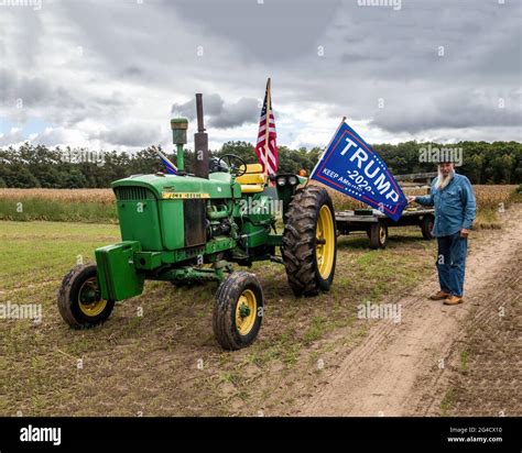 Farmer John With His John Deere 3020 Tractor Holding Out A Trump Banner