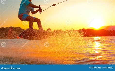 Close Up Cool Wakeboarder Does A 180 Ollie While Speeding Across The