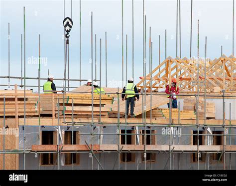 Building Contractors At Work On Housing On A Construction Site