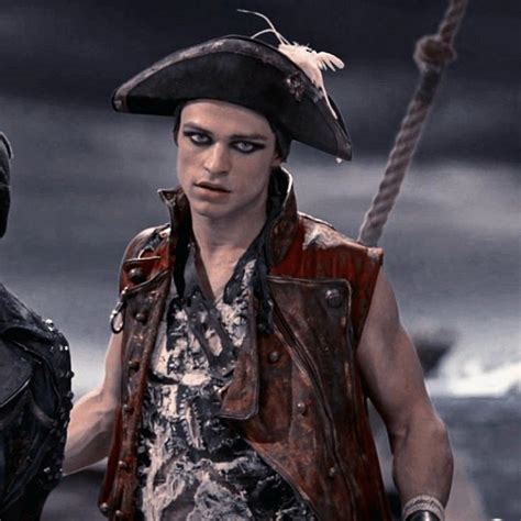 A Man In Pirate Costume Standing Next To Another Man