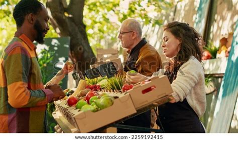 Happy Customers Visiting Farmers Market Stand Shutterstock