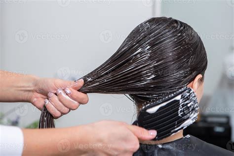 Hairdresser Applies A Hair Mask To Straight Black Hair Hair Care At