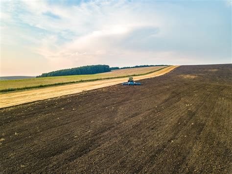 Premium Photo Aerial View Of A Tractor Plowing Black Agriculture Farm