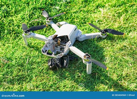 Accident with a Drone. Damaged Quadcopter on Green Grass Stock Photo ...