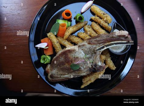 Grilled Porkchop on wood background Stock Photo - Alamy