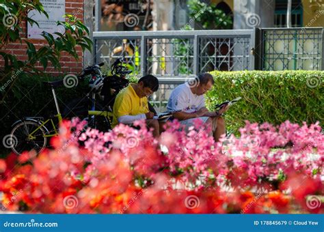 Two Artist Drawing At Park With Red Flower Decoration During Chinese