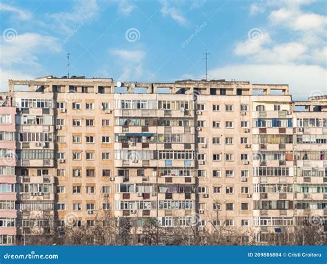 Worn Out Apartment Building From The Communist Era Against Blue Sky In