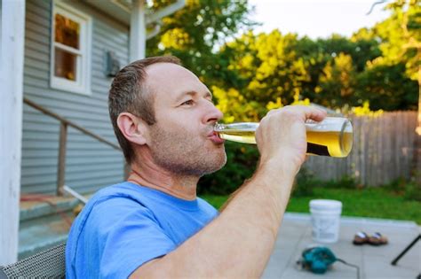 Premium Photo Midsection Of Man Drinking Glass Against Trees