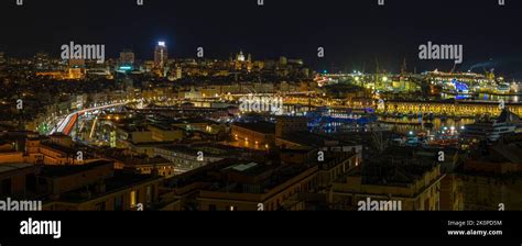 Panoramic View Of Genoa At Night With The Causeway And The Buidings Of